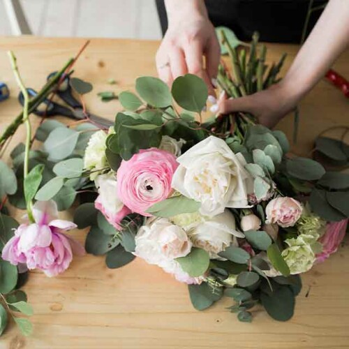 Woman creating rose bouquet